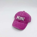Close-up of white MINI towel embroidery on a washed dark pink baseball cap - Kids MINI / Rose Red