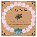 Pink beaded turtle energy bracelet with a blue turquoise-style turtle charm on card - Rose Quartz