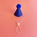Close-up of blue felt pet party hat with matching pompom and adjustable elastic strap - Royal Blue Birthday Hat