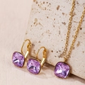 Detail view of purple square-cut zircon jewelry set with gold necklace and earrings - Purple