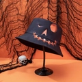 Close-up of black Halloween bucket hat featuring a vibrant orange glowing pumpkin face print - M (56-58cm) / Black Pumpkin Ghost Face-12