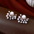 Close-up of elegant fan-shaped pearl earrings with zirconia on brown leather background - Silver (Silver Pin)
