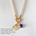 Elegant pearl necklace featuring a textured gold M letter pendant and blue crystal - Letter M