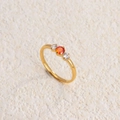 Three-stone titanium steel ring with central orange gem and gold-plated finish - Gold White and Red Zirconia