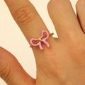 Close-up of 18K gold-plated stainless steel ring featuring a pink enamel bow detail - Girly Pink Enamel Bow Style (DZ-549)