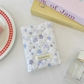 Close-up of quilted cotton passport holder with lavender bear pattern and woven label - Star Bear