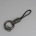 Porte-clés en métal gris fusil avec dragonne en cuir tressé noir pour voiture - Gris + Gunmetal