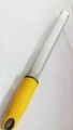 Stainless steel cheese grater and lemon zester with a bright yellow ergonomic handle - Fine Teeth Yellow