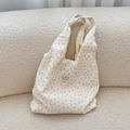 Close-up of cream floral tote bag with bubble pleat texture and sozakka label detail - Beige Purple Flower