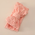 Detail of pink stretch baby headband featuring oversized bow and 3D textured knit fabric - Carmine Pink