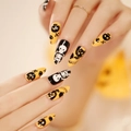Halloween press-on nails with yellow and black skull skeleton 3D designs on long stiletto tips - JP1249