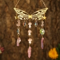 Detail of golden butterfly suncatcher with pink crystals and ceramic mushrooms hanging outdoors - Gold Wings + Rose Quartz