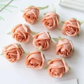 Nine champagne silk rose heads for DIY crafts without stems on a white background - Nude Pink