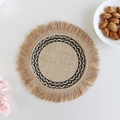 Round jute placemat with beige fringe and black wave embroidery in a cozy setting - Type F Jute Coaster