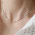 Detail view of a silver snake chain necklace with beads worn on the neck - Silver Round Bead Snake Chain