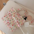 Detail view of pink quilted tote bag with floral tulip print and cosmetic essentials - Pink Small Floral