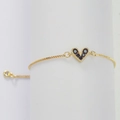 Elegant gold heart bracelet for women with black zircons on a white cylinder stand - Black