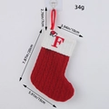 Classic red knitted Christmas stocking featuring embroidered letter F and white cuff detail - Letter F