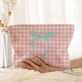 Pink houndstooth corduroy cosmetic bag featuring a contrasting teal bow print design - Pink Houndstooth Cyan Bow (RP377270)