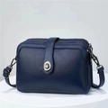 Deep blue leather crossbody bag with triple zippers and metallic swivel lock on white stand - Blue