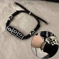 Close-up of adjustable braided cord bracelet with nine-eyed Dzi bead and black agate beads - Bracelet / Black