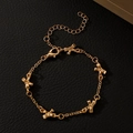 Detail of gold bow bracelet charms on black leather background with lobster clasp - Gold Bow Bracelet (N-1089)