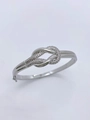 Detailed close-up of silver knotted bangle featuring shimmering pave cubic zirconia stones - Bangle / White Gold