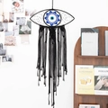 Handwoven black cotton macrame wall hanging with a blue and white evil eye pattern - Evil Eye - Black