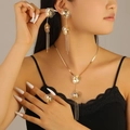 Exquisite gold floral jewelry set with dangling tassels on an elegant female model - Tassel Flower Style (5198) / Gold