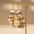 Detailed macro view of gold layered petal tassel earrings with small gemstone accents - Gold