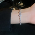 Detailed view of luxury zircon bow bracelet on wrist with sparkling crystals - Silver Bowknot