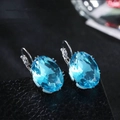 Elegant sky blue oval gemstone earrings with classic silver prong setting for women - Sky Blue