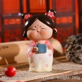 Close-up of a Tang Dynasty style girl figurine holding a blue scroll for desk decor - Large Reading Lady
