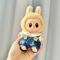 Labubu doll in yellow bunny ears and denim overalls with green bear button decor - Pink Heart-patterned Bear T-shirt + Designer Overalls / First And Second Generation Keychains Are Compatible With La Cloth Dolls. Dolls Not Included.
