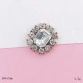 Macro shot of 16x17mm flower charm with rectangle center crystal and antique alloy base - Gemstone Style