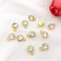 Golden round 7mm birthstone pendant with clear rhinestone and hanging loop for DIY jewelry - Gold April - Transparent