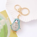 Macro detail of a sparkling penguin keychain with blue crystals on a white ceramic shell - Penguin 3 (Blue)
