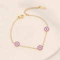 Detailaufnahme der lila Evil Eye Anhänger an einem vergoldeten Edelstahl Armband - Lila