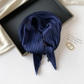 Detailed view of dark blue pleated silk scarf with fine vertical texture in a tray - 70*70cm / Pleated Dark Blue