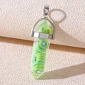 Detail of a resin hexagonal prism pendant with green kiwi slices and silver bail - Resin Kiwi