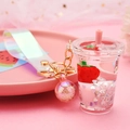 Detail of strawberry milk tea cup keychain with liquid charms and iridescent wrist strap - Strap Clasp + Milk Tea Cup + Bead / Pink
