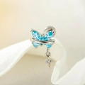 Silver butterfly cross earring with blue gemstone accent on soft white petals - Light Sea Blue (1 Pc)
