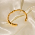 Minimalist 18K gold-plated stainless steel open bangle with teardrop ends on beige silk - Teardrop Thickened Shape - Gold (s439jin)