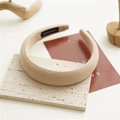Close-up of beige knitted sponge headband featuring a handmade label and soft texture - Milk Tea