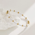 Chic bamboo style white enamel bangle with gold accents on white stone background - White