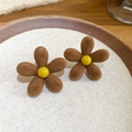 Close-up of brown flocked flower earrings with yellow centers and silver needles - Brown