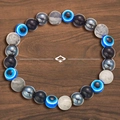 Elastic bracelet with blue Evil Eye beads and black volcanic stone for wealth and abundance - Money