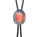 Close-up of western bolo tie with orange gemstone inlay and silver floral engraving - Coral