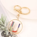 Detailed macro view of gold letter U keychain with colorful rhinestones on ring - Letter U