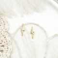 Detail of lightning bolt charms in 18K gold plating with micro-pave crystals on lace fabric - Double Loop Mini Lightning